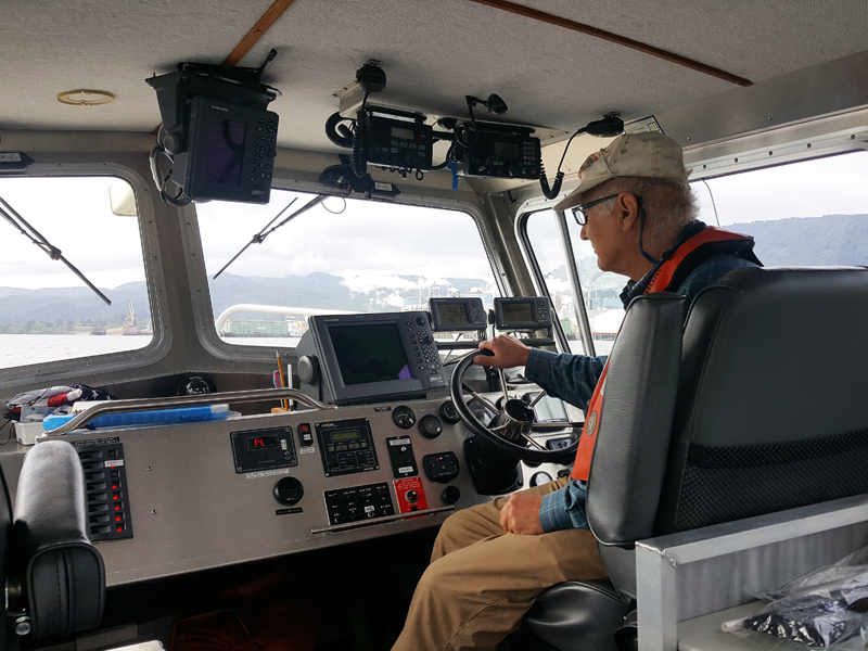 OAIs Bill Newcomb piloting research boat